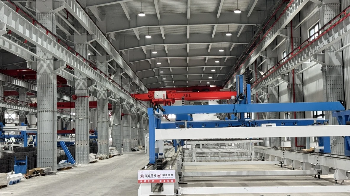 Current Wuhan factory interior with gantry equipment and production beds